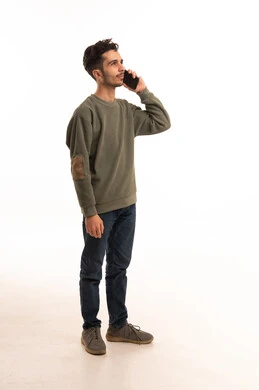 Young Arab Man Talking on Smartphone against White Background