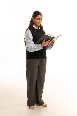 Saudi Female Student Reading a Book in School Uniform