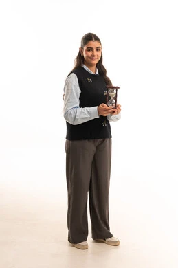 Saudi Female Student Holding Hourglass in Studio