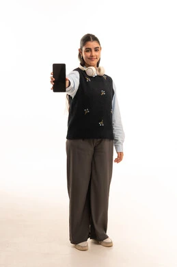 Saudi Woman Holding Smartphone with Blank Screen in Studio