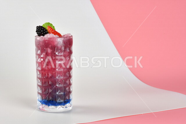 Close-up of mojito juice with fresh fruits, strawberry and cranberry pieces, cold drinks, delicious natural juices, healthy and useful juice, refreshing and iced summer cocktail