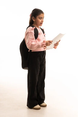 Saudi Student Reading Paper with School Backpack
