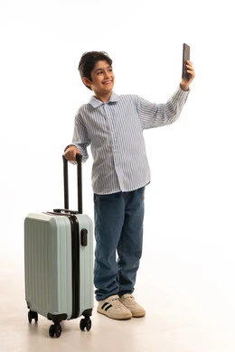 Saudi Boy with Travel Suitcase and Smartphone Studio
