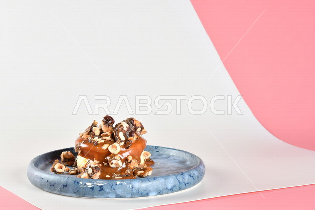 طبق من الحلا البارد مزين بالكراميل والبندق اللذيذ ، حلا شرقي ، حلويات رمضانية ، حلويات وسكريات ، قطع الحلوى الشهية ، التحلاية ، حلويات باردة لذيذة