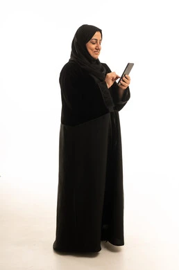 Saudi Woman in Black Abaya Using Smartphone