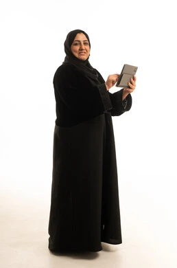 Middle Eastern Woman in Black Abaya Holding Tablet