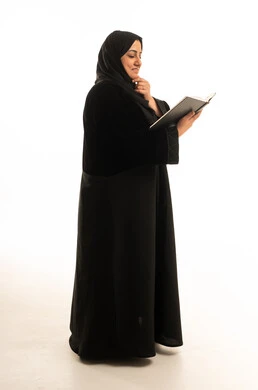 Saudi Woman in Black Abaya Reading Book in Studio