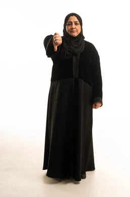 Saudi Woman in Abaya Giving Thumbs Down Gesture