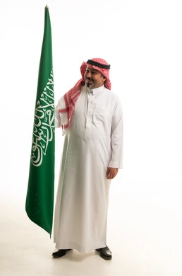 Saudi Man Holding Saudi Arabia National Flag in Studio