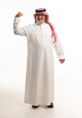 Senior Saudi Man Flexing Muscle in Traditional Thobe