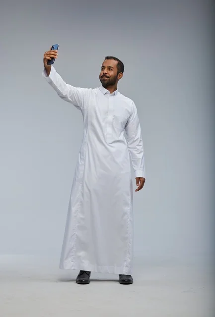 Saudi Man in White Thobe Taking Smartphone Selfie Studio