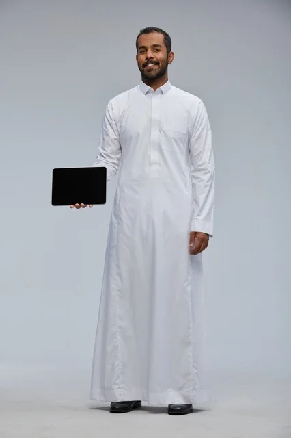 Saudi Man in White Thobe Holding Tablet Studio