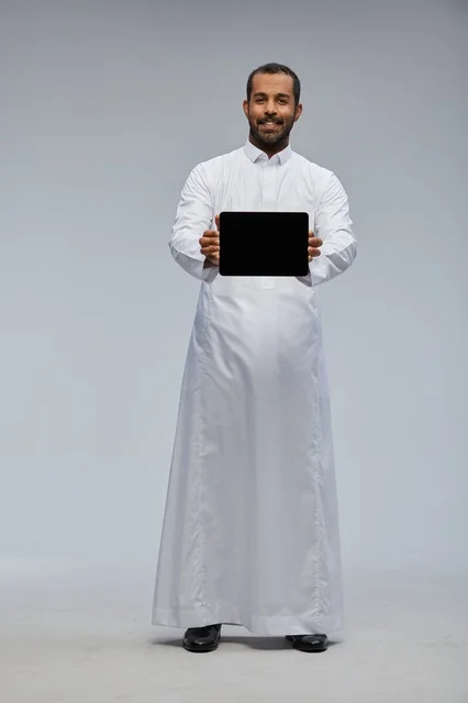 Saudi Man in White Thobe Presenting Digital Tablet