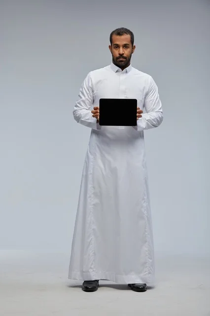 Saudi Man in White Thobe Holding Tablet Mockup
