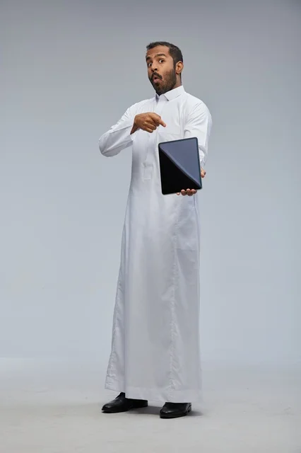 Saudi Man in White Thobe Pointing at Tablet Studio