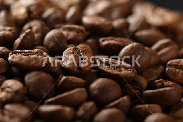 Close-up of roasted coffee beans, coffee beans, making and preparing fresh coffee, making hot drinks from coffee beans