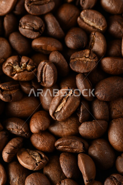 Close-up of roasted coffee beans, coffee beans, making and preparing fresh coffee, making hot drinks from coffee beans