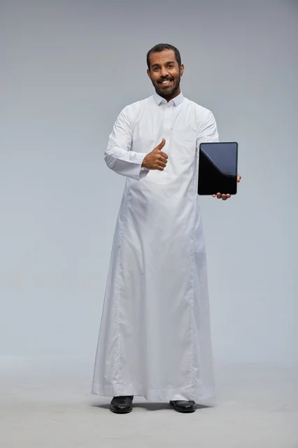 Saudi Man in White Thobe Holding Tablet Thumbs Up