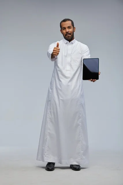 Saudi Man in Thobe Holding Tablet with Thumbs Up