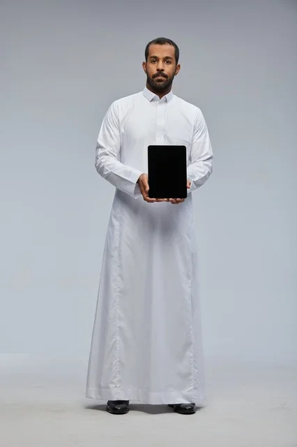 Saudi Man in Thobe Holding Digital Tablet Studio