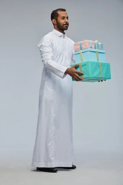 Saudi Man in Traditional Thobe Holding Gift Boxes