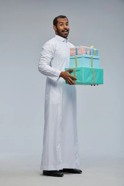 Saudi Man in Traditional Thobe Holding Gift Boxes