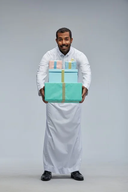 Saudi Man in Traditional Thobe Holding Gift Boxes