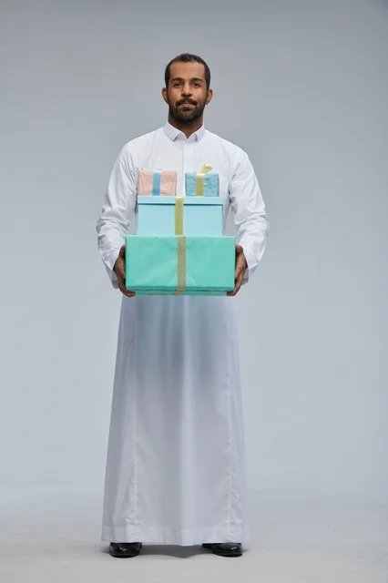 Saudi Man in Traditional Thobe Holding Gift Boxes
