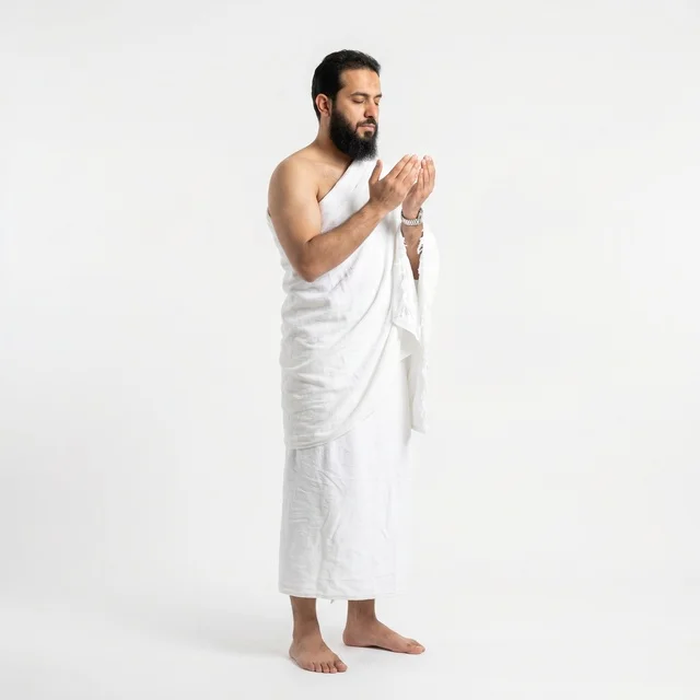 Muslim Man in Ihram Praying on White Background Muslim Man in Ihram Praying on White Background
