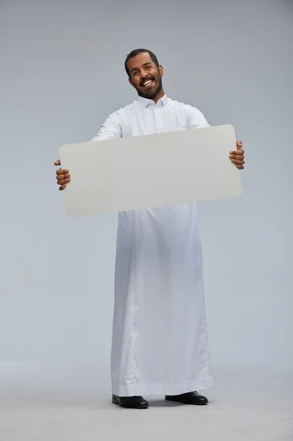 Saudi Man in Thobe Holding Blank Sign Board