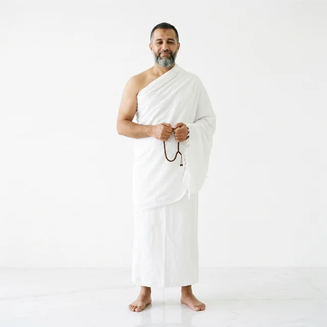 Muslim Man in Ihram Holding Prayer Beads in Studio
