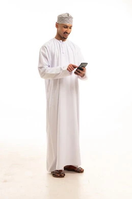 Omani Man in Traditional Dress Using Smartphone