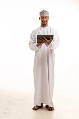 Omani Man in Traditional Dress Using Digital Tablet