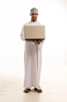 Omani Man in Traditional Dress with Laptop