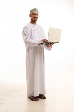 Omani Man with Laptop in Traditional White Dishdasha