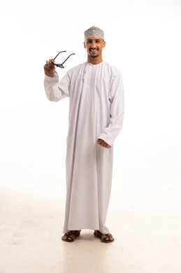 Omani Man in Traditional Dishdasha Holding Sunglasses