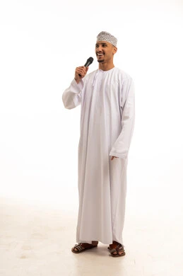Omani Man in Traditional Dress Speaking into Microphone