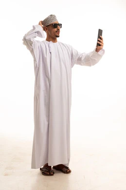 Omani Man in Traditional Dress Taking Selfie on White