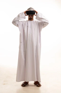 Omani Man in Traditional Dress Using VR Headset