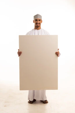 Omani Man in Traditional Dress Holding Blank Board Omani Man in Traditional Dress Holding Blank Board