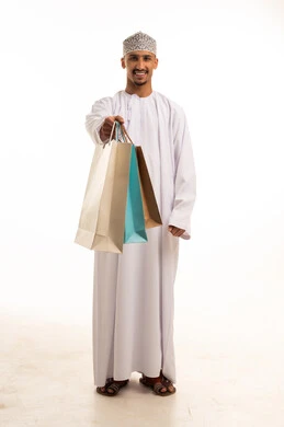 Omani Man in Traditional Dress Holding Shopping Bags
