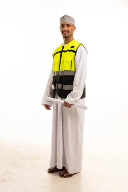 Omani Engineer in Safety Vest with Construction Plans