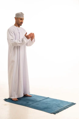 Omani Man Praying in Traditional Dishdasha and Kumma