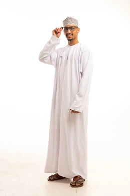 Omani Man in Traditional Dishdasha and Kumma Cap