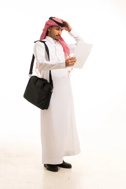 Saudi Man in Thobe Confused Holding Paper in Studio
