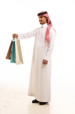 Saudi Man in Traditional Thobe Holding Shopping Bags