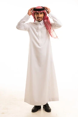 Saudi Man in Traditional Thobe Adjusting Agal
