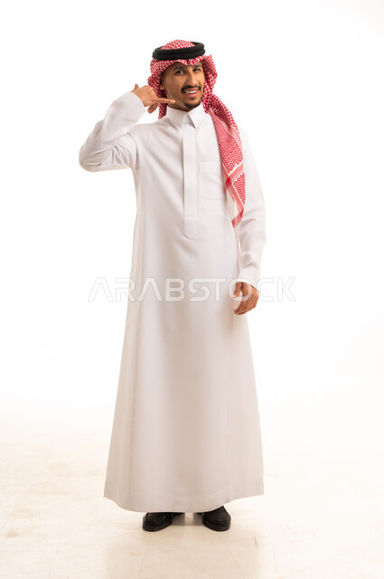 رجل سعودي بالزي التقليدي يقوم بإشارة الاتصال