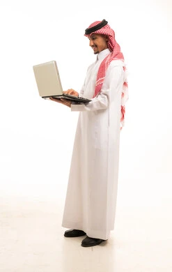 Saudi Man Using Laptop on White Background