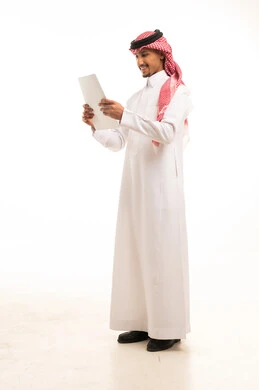 Saudi Man in Traditional Thobe Reading Document
